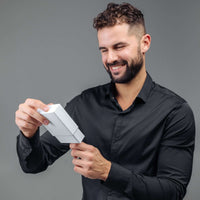 Thumbnail for Man Blue Photo Bracelet gift being unwrapped by a smiling man, showcasing personalized jewelry from Brother & Sisters.