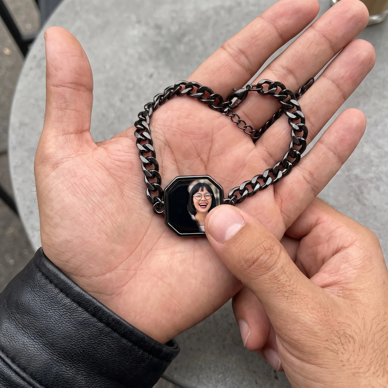 Thumb warming the black octagon bracelet plate: the hidden photo appears under the thumb while the rest stays black | SKU: TPH-OCTB-BLACK-18