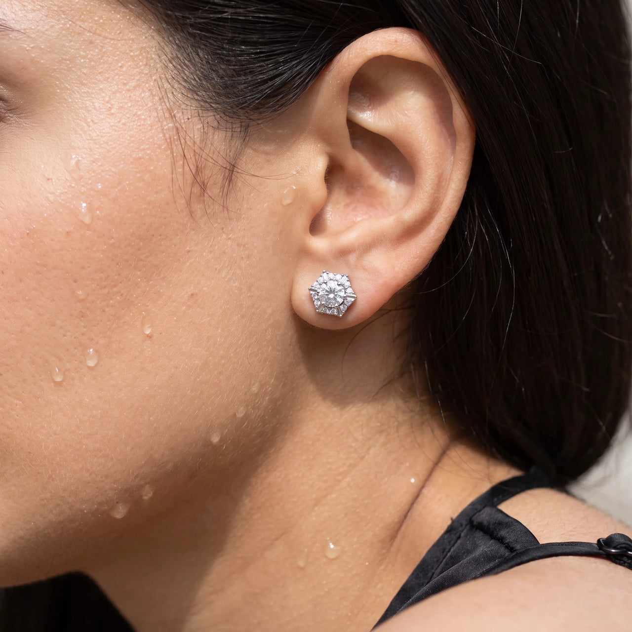 Close-up of the silver stud earrings worn on the skin | SKU: 30876249