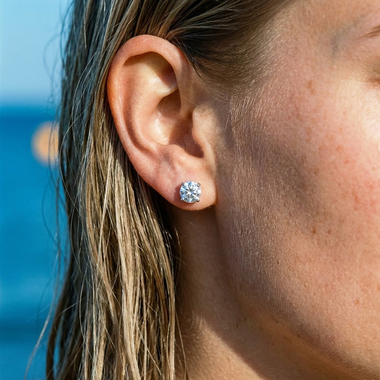Solitaire Crystal Studs in Silver, close-up on the earlobe | SKU: 41010-silver